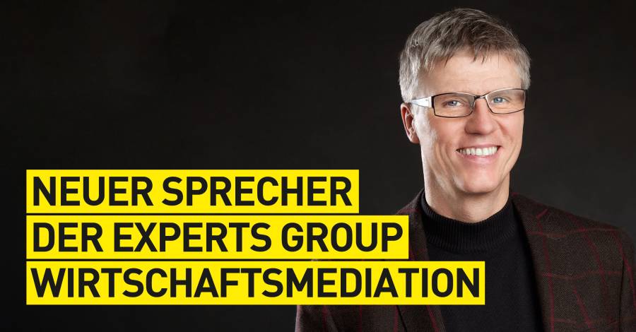 Porträt eines Mannes im braunen Anzug, Text „Neuer Sprecher der Experts Group"